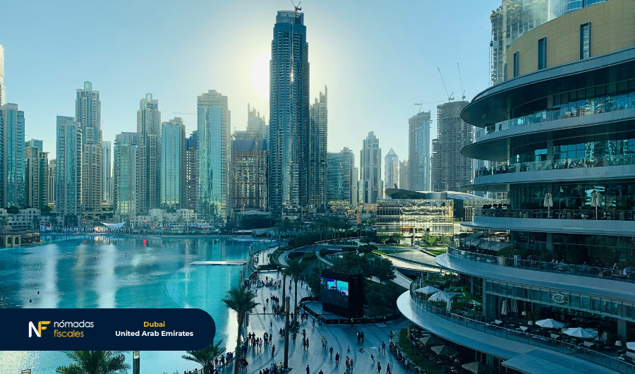 Downtown Dubai view with the Dubai Fountain, skyscrapers and people walking at sunset